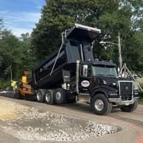 Big Boy Trucking dump truck delivering gravel